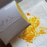 Photo of warped Pelikan Edelstein ink box and paper towel with precious Golden Beryl ink soaked into it after spill caused by not properly screwing cap onto bottle.